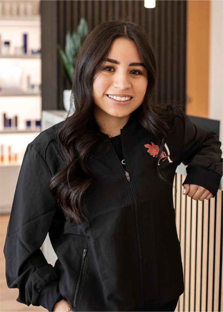 Sydney Saia standing at Ascent Med Spa