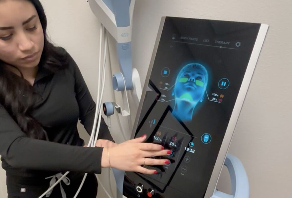 Woman setting up Emface machine at Ascent Med Spa