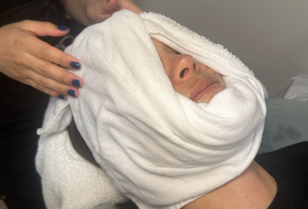 Towel wrapped around face during a facial
