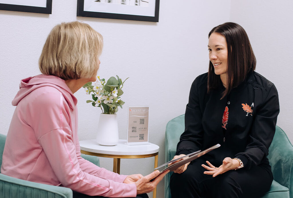 Dr. Kim Westbrook consulting with a woman about the Ascent Med Spa wellness program