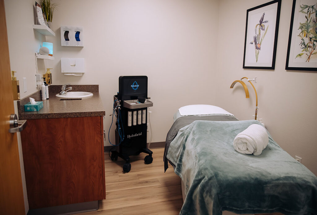 Hydrafacial machine, light, and bed for facials at Ascent Med Spa